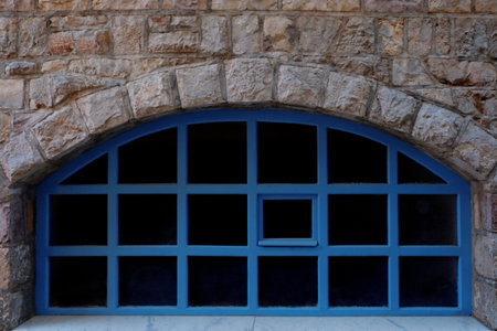 View of old arch window in stone wall, closeup