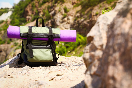Backpack with sleeping mat outdoors on sunny dayの写真素材