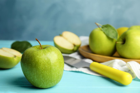 Composition with fresh ripe green apples on blue wooden table, space for textの写真素材