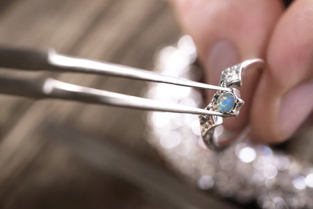 Male jeweler examining ring in workshop, closeup viewの写真素材