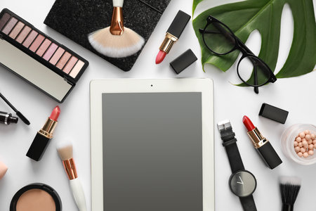 Composition with tablet, makeup products and accessories on white background, top view. fashion bloggerの写真素材