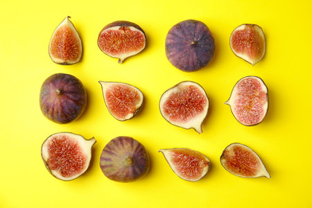 Tasty fresh fig fruits on yellow background, flat layの写真素材