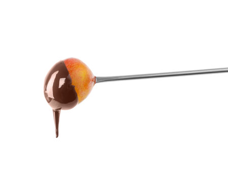 Tasty grape dipped into chocolate fondue on white backgroundの写真素材