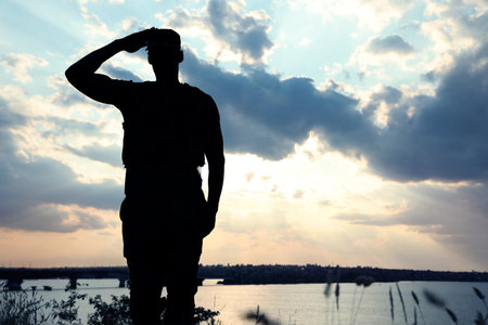 Soldier in uniform saluting outdoors. military serviceの写真素材
