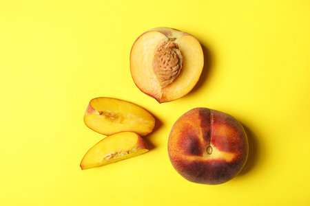 Flat lay composition with ripe peaches on yellow backgroundの写真素材