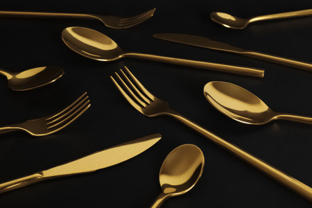 Set of luxury gold cutlery on black backgroundの写真素材