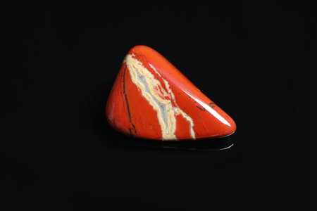 Beautiful red and white jade gemstone on black backgroundの写真素材