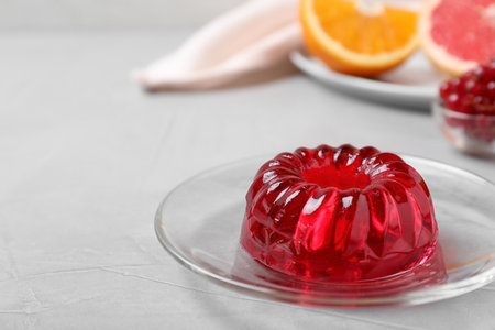Delicious fresh red jelly on gray table, space for textの写真素材