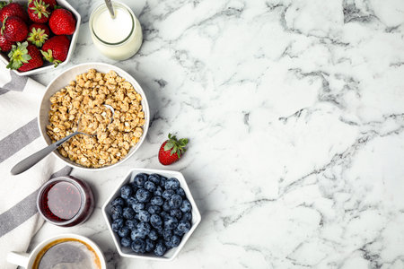 Tasty breakfast served on white marble table, flat lay. Space for textの写真素材