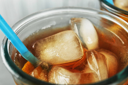Glass of delicious refreshing iced tea, closeup