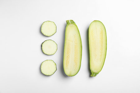 Fresh ripe cut zucchinis on white background, top viewの写真素材