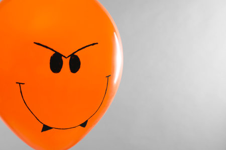 Spooky balloon for Halloween party on light gray background, space for textの写真素材