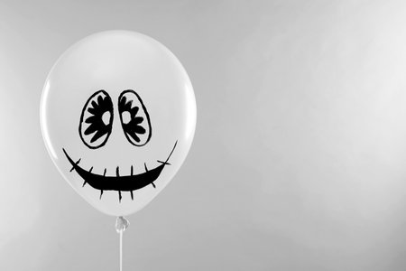 Spooky balloon for Halloween party on light gray background, space for textの写真素材