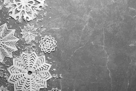 Flat lay composition with paper snowflakes on marble background, space for text. winter seasonの写真素材