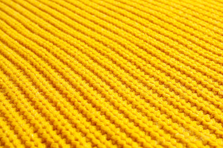 Yellow winter sweater as background, closeup viewの写真素材