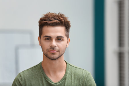Portrait of a handsome young man in the roomの写真素材