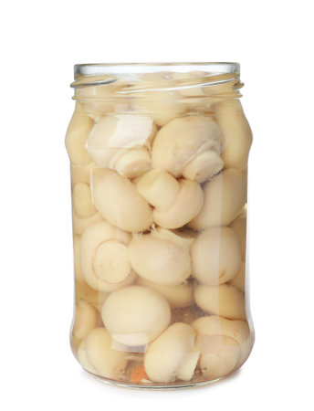 Glass jar with pickled mushrooms isolated on whiteの写真素材