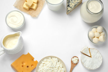 Frame made with different dairy products on white background, top view. Space for textの写真素材