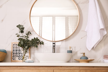 Stylish bathroom interior with vessel sink and round mirrorの写真素材