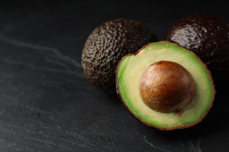 Delicious ripe avocado on dark gray table