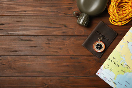 Flat lay composition with camping equipment on wooden background. Space for textの写真素材