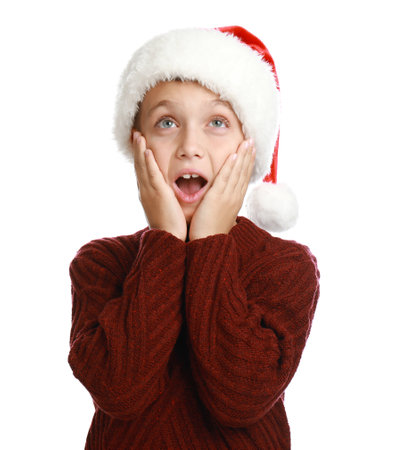 Emotional little child in Santa hat on white background. christmas celebrationの写真素材