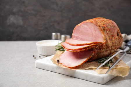 Delicious cooked ham served on gray tableの写真素材