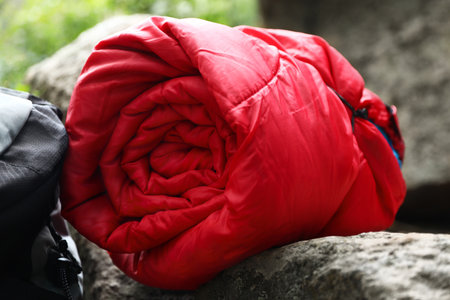 Rolled sleeping bag outdoors on sunny day, closeupの写真素材