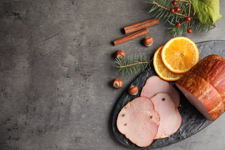 Flat lay composition with delicious ham on gray table, space for text. christmas dinnerの写真素材