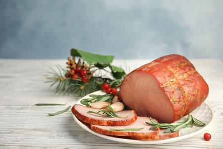 Delicious ham served on white wooden table. christmas dinnerの写真素材