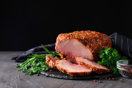 Homemade delicious ham on gray table, space for text. Festive dinnerの写真素材