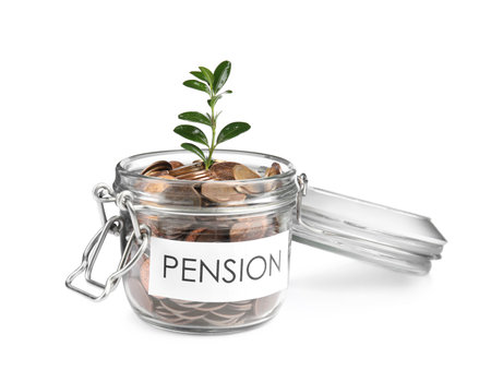 Glass jar with label PENSION, coins and green plant isolated on whiteの写真素材