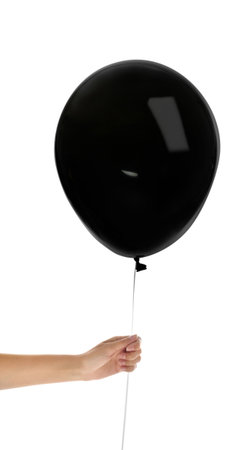 Woman holding black balloon on white background. halloween partyの写真素材