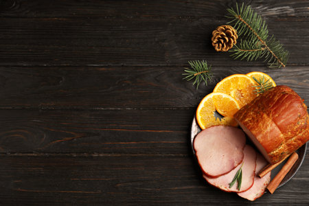 Flat lay composition with delicious ham on black wooden table, space for text. christmas dinnerの写真素材