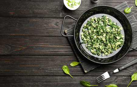 Flat lay composition with tasty spinach and space for text on black wooden table. healthy foodの写真素材