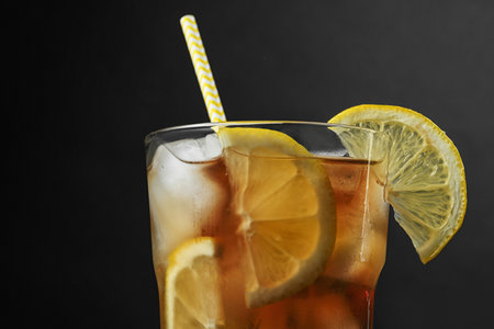 Glass of delicious iced tea against black background, closeupの写真素材