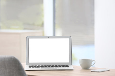 Modern laptop on desk in room. home workplaceの写真素材