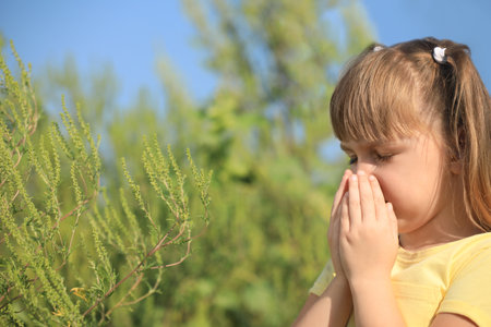 Little girl suffering from ragweed allergy outdoorsの写真素材