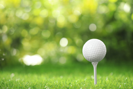 Golf ball on tee at green courseの写真素材