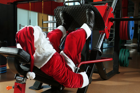 Authentic Santa Claus training in modern gymの写真素材