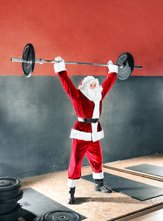 Young Santa Claus training in modern gymの写真素材