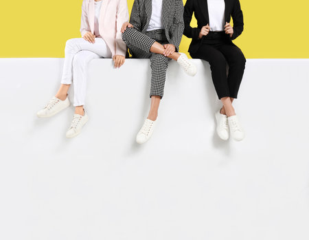 Women wearing stylish shoes on color background, closeupの写真素材