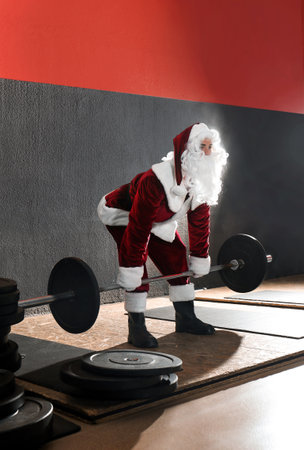 Young Santa Claus training in modern gymの写真素材