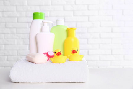 Baby accessories on table near white brick wall. Space for textの写真素材