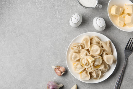 Flat lay composition with tasty dumplings on light gray table, space for textの写真素材