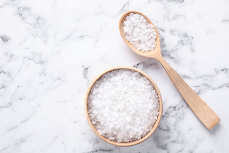 Flat lay composition with white sea salt on marble background, space for text. spa treatmentの写真素材