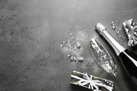 Flat lay composition with bottle of champagne for celebration on gray stone background. Space for textの写真素材