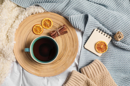 Flat lay composition with cup of hot winter drink on light fabricの写真素材