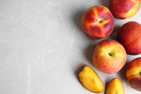 Fresh juicy peaches on marble table, top view with space for textの写真素材