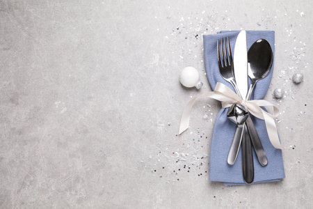 Cutlery set on gray table, top view with space for text. christmas celebrationの写真素材